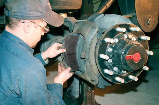 How do tractor brakes differ from automotive brakes?