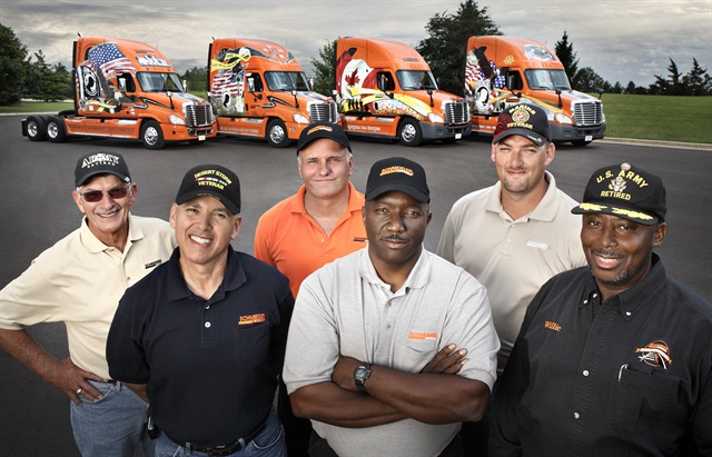 Schneider National has had active programs recruiting former military drivers like these for years. In the background are its Ride of Pride trucks, special veteran-themed trucks built by Freightliner to participate in the Rolling Thunder Ride of Pride on Memorial Day as well as in other events.